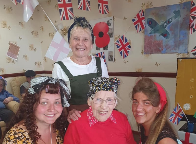 A resident and staff at The Sands care home enjoying VE Day.