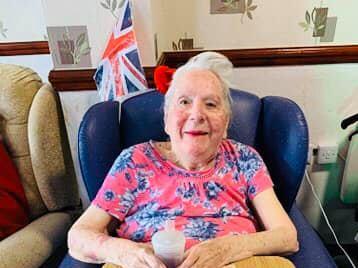 A resident at The Sands care home enjoys VE Day.