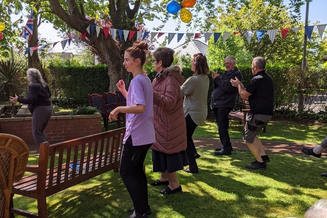 Staff and residents at The Sands Meadows in Hest Bank enjoy activities for VE Day in the garden.