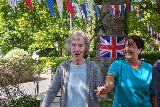 A resident and staff at The Sands Meadows care home in Hest Bank celebrate VE Day in the garden.
