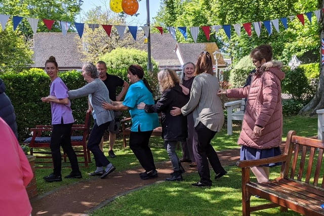 Residents and staff at The Sands Meadows care home in Hest Bank do the conga during VE Day celebrations.