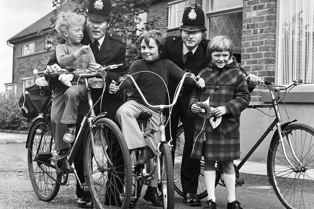 Local policemen and children in Abram in August 1976. It had just been announced that bobbies on bikes were to be reintroduced in the Wigan area.