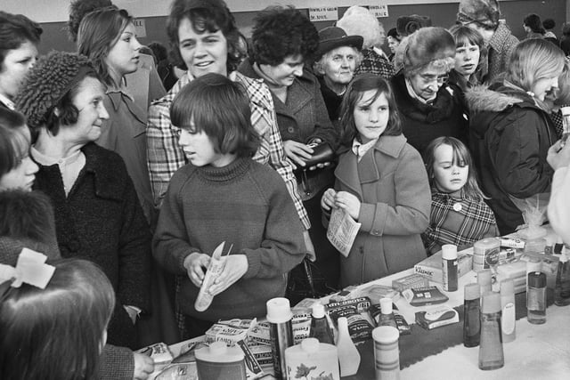 A typical Saturday afternoon photographic assignment on the 27th of March 1976 and bargain hunters at The Deanery High School bazaar.