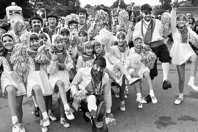 Keeping in step are morris dancers of different codes with the Platt Bridge Debutantes and the Horwich Prize Medal Morris Men at Wigan Infirmary garden party on Saturday 18th of August 1979.