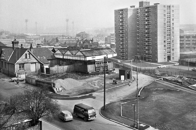 A view across Station Road showing Central Station and the Scholes flats in the foreground with Wigan Little Theatre, Walter Heyes Electrical Works and Central Park in the background in the late 1960s.