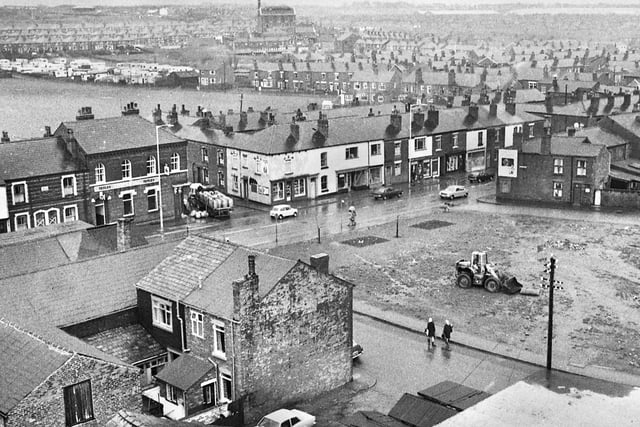 A view across Manchester Road, Higher Ince, with a dray wagon in Hall Street delivering beer to the Imperial pub.  Opposite is land between Anderton Street and Bird Street being cleared for development around 1970.