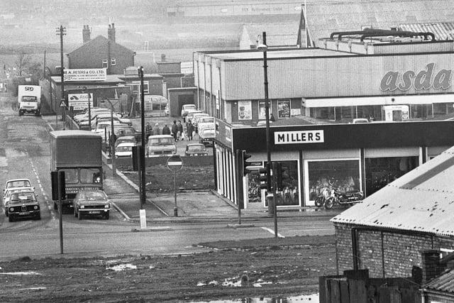 A view down Soho Street, Newtown, in November 1974. In the foreground is Millers motorcycles with the Asda store behind. Centre is M.A. Peters gardening and home improvement centre with the edge of Wigan small bore rifle club on the left.