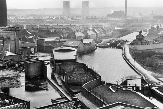 A misty day view from Higher Ince along the Leeds and Liverpool canal towards Westwood power station around 1970.
