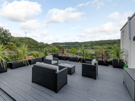 This stunning four bedroom property, currently for sale with Fine & Country, offers breath-taking views of Oliver's Mount and beyond. This property has a gym, large kitchen and roof balcony.