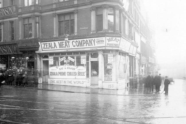 Duncan Street on Briggate. Owen & Robinson Ltd, jewellers to left, then Zeala Meat Company - butchers. Call Lane to right. Groups of men both on Duncan Street and in front of the Zeala Meat Company.