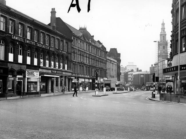 Duncan Street in the 1970s looking west from the junction with New Market Street. On the left are Frank's Gents Hair Stylist and The Duncan pub. Visible on the right are Evans Outsize Clothes then Holy Trinity Church and C & A further along on Boar Lane.