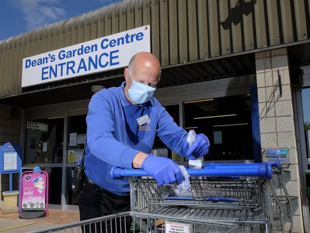 Deans Garden Centre manager Jim Cockerton wiping down the trolleys