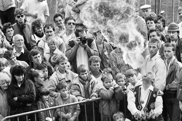 A fire-eater wows the crowds at Haigh Carnival on Bank Holiday Monday 29th of August 1988.