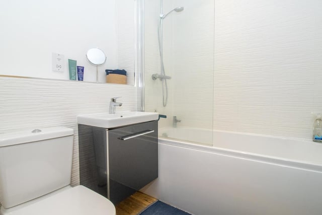 The beautifully finished bathroom has a  toilet, square wash hand basin with mixer tap and a thermostatic 'Rainfall' shower head fitted/glazed shower screen.