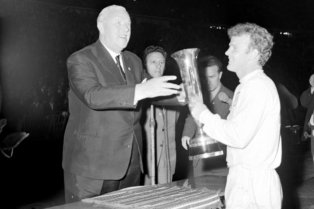 Billy Bremner is presented with the trophy. The Whites held off an onslaught from Ferencvaros in the Nep Stadium.