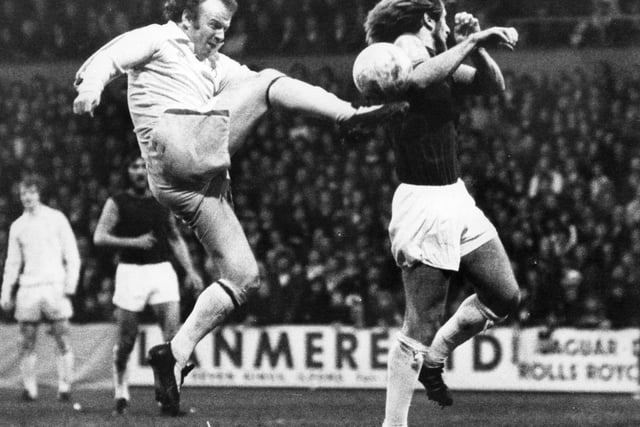 Billy Bremner leaps high to kick the ball as West Ham United's Graham Paddon attempts a block at Upton Park.