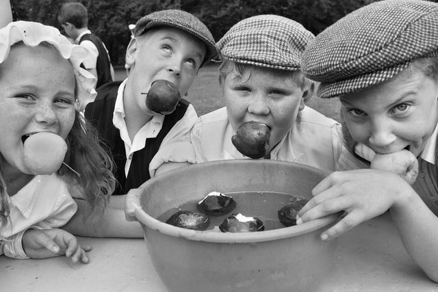 Pupils of Rectory CE Primary School, Garswood, who were trying their hand and mouths at Victorian games such as bob apple for the day on Friday 19th of May 1989.