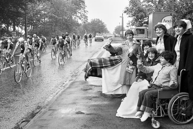 Patients and nurses watch the Milk Race cyclists pedal past Wrightington Hospital on Monday 2nd of June 1980.