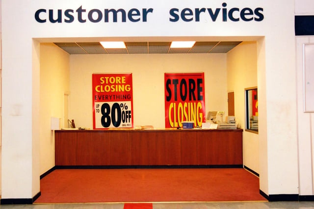 The customer services desk on the third floor. Notices behind the desk say 'Store Closing' and 'Everything Up To 80% Off'.