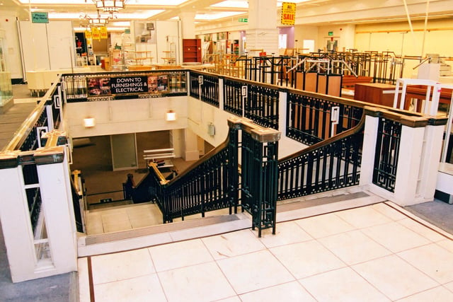 The staircase from the ground floor down to the basement at the New Briggate end of the building. Taken at the time of it's closure in 2005, the store is looking bare except for a few fixtures and fittings which are advertised as being for sale.