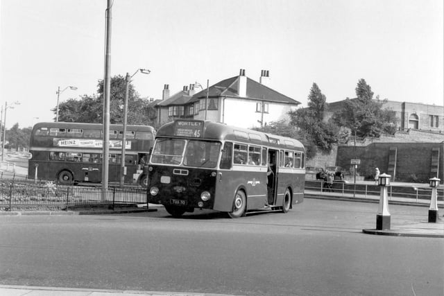 Single deck Leyland Tiger CUb/Roe 30 turning at Harehills roundabout. To the right is the car park of the Fforde Grene Public House on Harehills Lane.