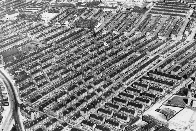 An aerial view of back to back red brick terraced housing. Snaking round from the left edge into the bottom left hand corner is Roundhay Road. Joining it is Roseville Road and then off towards the right is Gledhow Road.