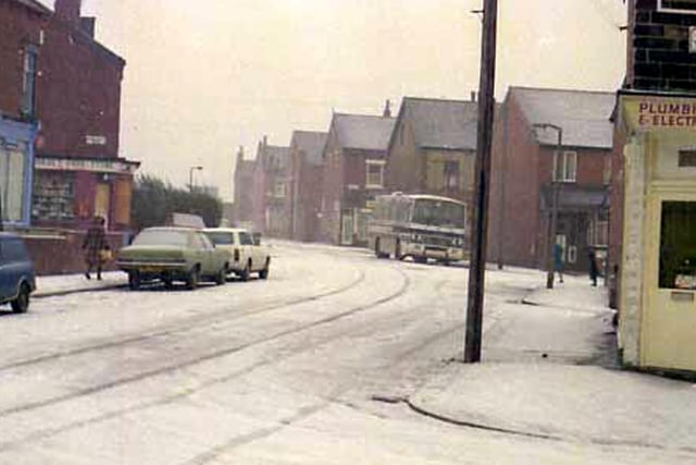 A recent snowfall covers the roads and footpaths of Dorset Road, seen from the junction with Dorset Terrace, right. A grocery shop is at the corner with Sandhurst Road, left and a plumbing & electrical business.