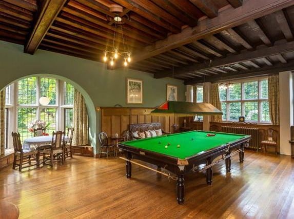 The Billiard Room is of particular note, with a recessed seating area and stunning fireplace. The finely proportioned dining room has another ornate fireplace behind a stone, broad round arch with a gilded figure of The Angel Of The Rains.