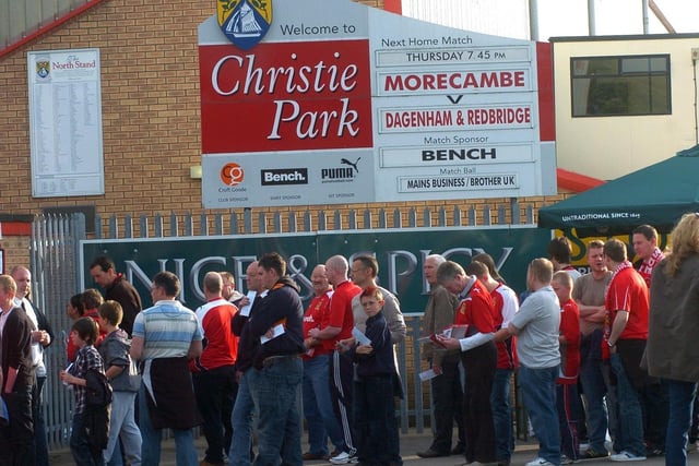Morecambe fans queue outside Christie Park for the play-off clash with Dagenham and Redbridge