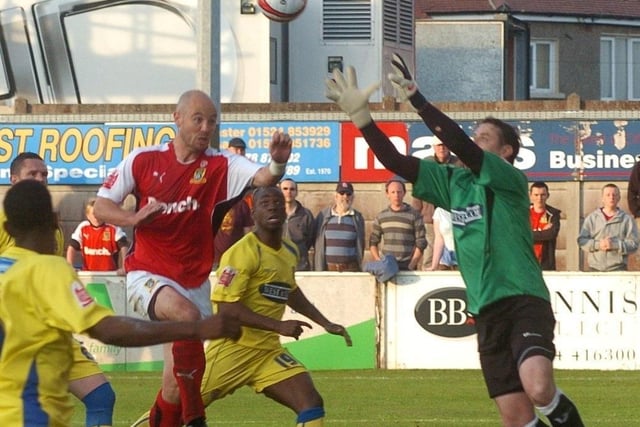 Morecambe's Paul Mullin challenges with Dagenham keeper Tony Roberts