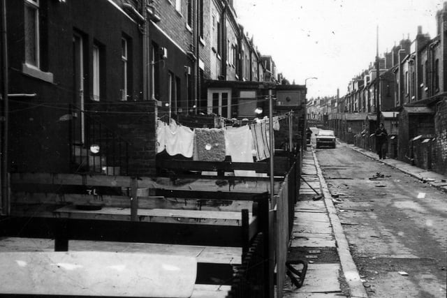 Terraced housing in Back Elford Place. The properties have back yards, and what would have been, outside toilets. The fronts of those houses on the left open onto Elford Place which is next to St. Aidan's Church and the south side of Banstead Park.