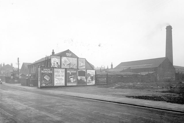 Florence Street off Compton Road. To the left is a petrol station selling 'Power Petrol' then there is a wall with 8 billposters affixed to it.