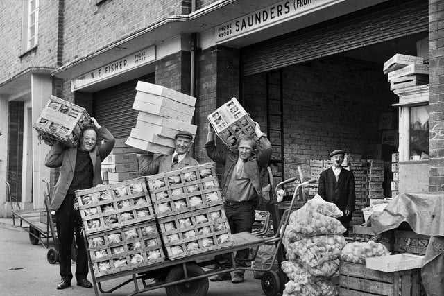 Unloading goods for Saunders fruit merchants at Wigan market hall in 1969.