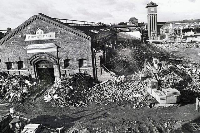 One of the last ever pictures taken of the old Wigan Market Hall before final demolition in 1988. The clock tower of the new market and Galleries can be seen rising in the background.