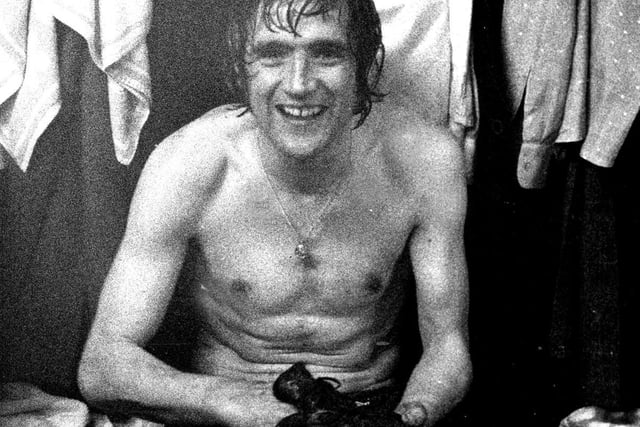 Norman Hunter smiles for the camera in the dressing room at full time.