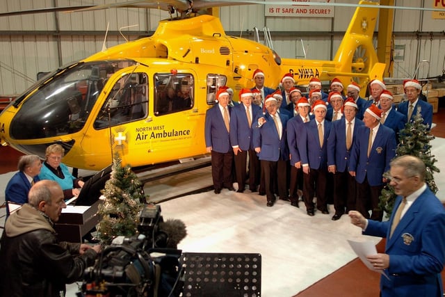 Blackpool Male Voice Choir filming with Paul Crone at Blackpool Airport, to raise money for the North West Air Ambulance.
