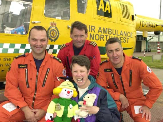 The North West Air Ambulance service celebrating its first year of operations. Preston nursery nurse Jean Poulton, helped with fundraising by knitting dolls, pictured with air crew Neil Howarth, Dave Strachan and Paul West.