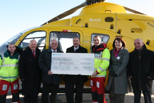 Estate Agents hand over a cheque for 500 to the Air Ambulance crew