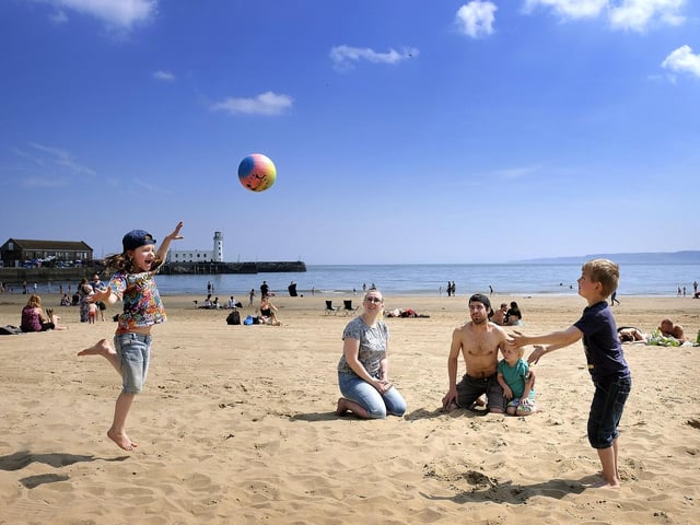 A family enjoys the sand.