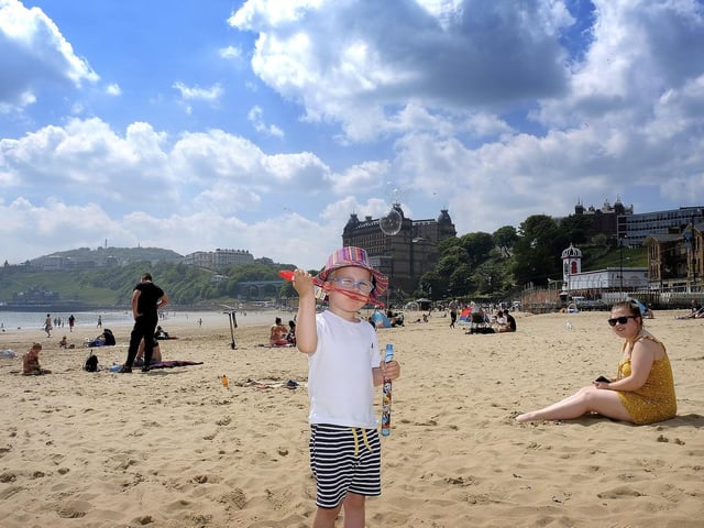 Riley Cooke has fun with bubbles as Mum looks on.