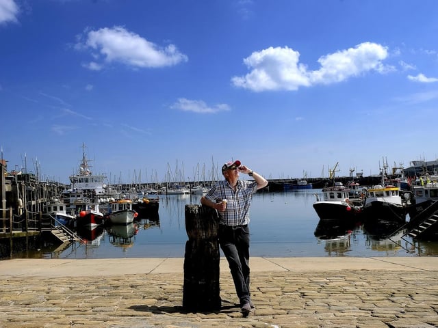 Enjoying an ice cream and the weather by the harbourside.
