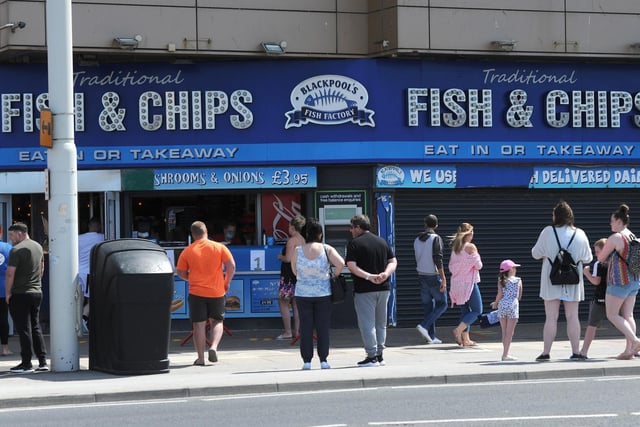 Customers observing social distancing while waiting for fish and chips.