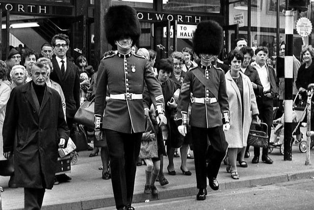Soldiers of the Irish Guards with shoppers in Wigan town centre before joining their regiment to entertain the crowds at Wigan Rugby Union Club gala day