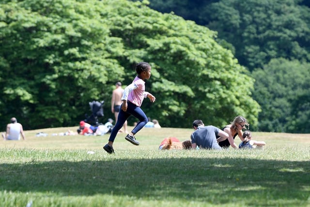 A young girl runs and plays in Roundhay Park.