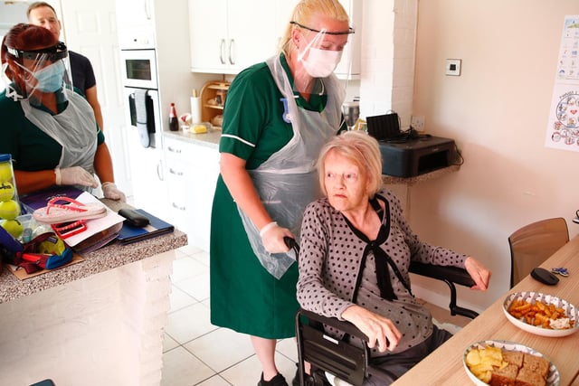 Covid-19 survivor, 83-year-old Marjorie Brunskill, the mother of the photographer, receives attention from NHS crisis team workers Angela and Clare after returning home from hospital, after testing negative for coronavirus (COVID-19), on May 27, 2020 in Blackpool (Picture: Clive Brunskill/Getty Images)