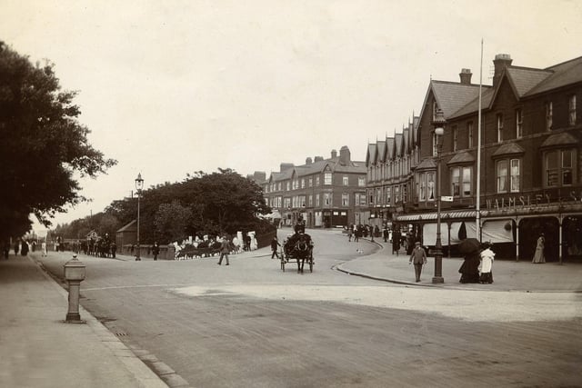 St Annes Road West leads off to the railway station on the left where landaus await their fares in this view looking towards The Crescent in 1900. The junction with Park Road can just be seen on the right with Walmsley and Son, dressmakers and milliners. Further along on the corner of St Andrews Road South is Finlay & Co advertising it's own smoke mixture.