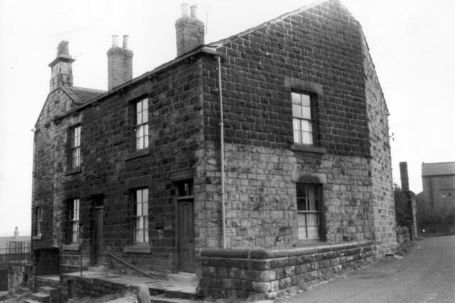 Stone terraced houses on Dryfield Yard showing steps to front door with iron railings visible.