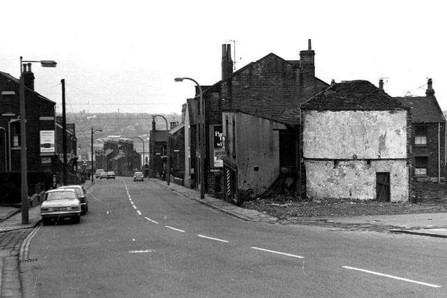 Looking north-east along Elland Road, showing the junctions with Little Lane on the right and Old Road on the left. Derelict outbuildings can be seen on the right.