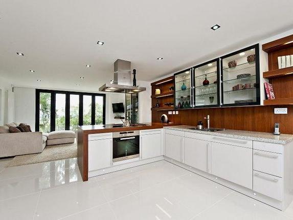 The ground floor is approached through an impressive glazed entrance and reception hall with central galleried landing and ash flooring. The lounge/dining room has full height double glazed picture windows overlooking the rear garden and country views. Fitted cocktail bar with door to an inner lobby leading to a cloaks cupboard and cloakroom.