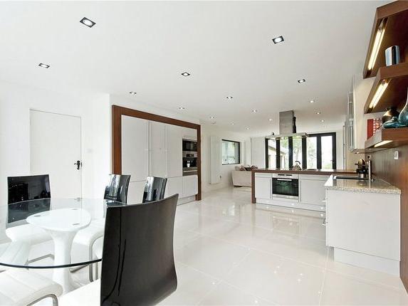 The superb luxury fitted family dining kitchen with sitting area has a comprehensive range of Siematic matt finish base units complemented by glazed illuminated crockery display cabinets and shelving, granite preparation surfaces and adjoining island with Miele induction hob and fan assisted oven with Blanco stainless steel cooker hood above. Matching Miele integrated appliances including combination oven, automatic coffee machine with warming drawer below, fridge freezer, dishwasher and two zone wine fridge, breakfast bar, porcelain tiled flooring and sitting area with folding doors opening out into the rear garden.